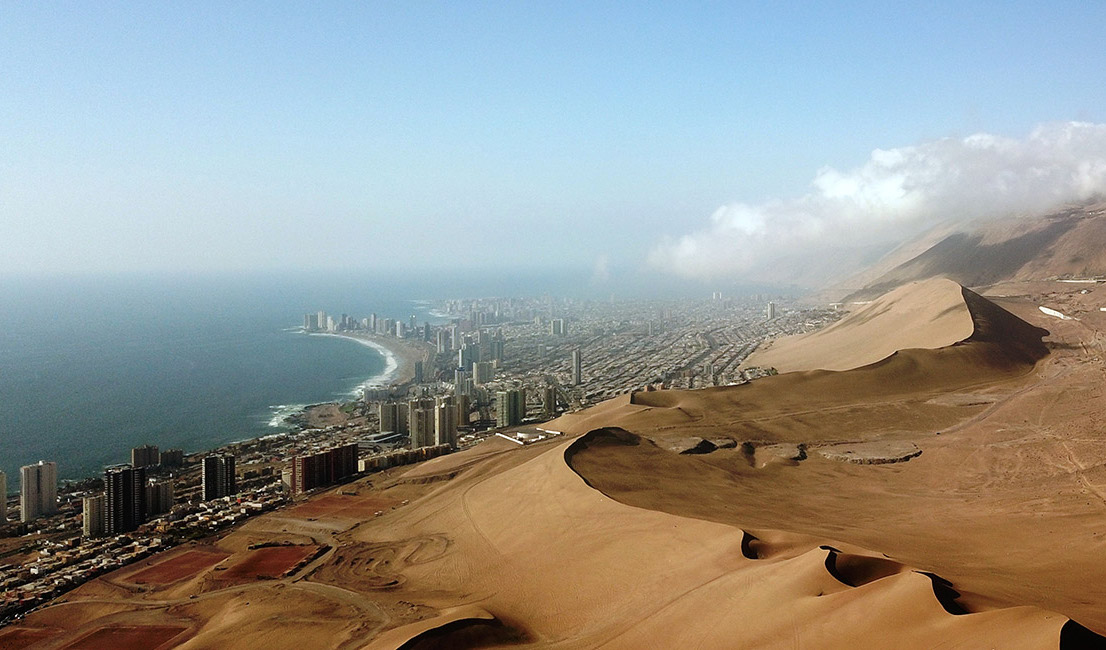 A city next to sand dunes.
