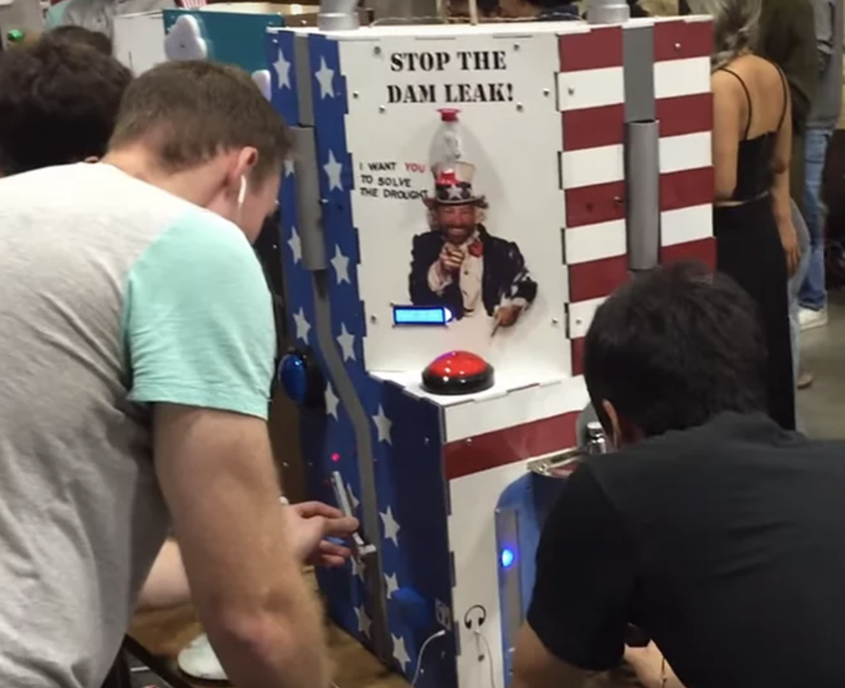 A picture of two man playing an arcade game