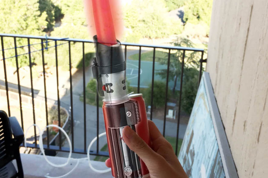 lightsaber overlayed over a can of coke.