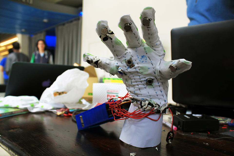 TouchMusic glove front view shows the glove standing on a table.